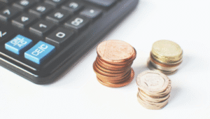 Coins stacked up next to a calculator