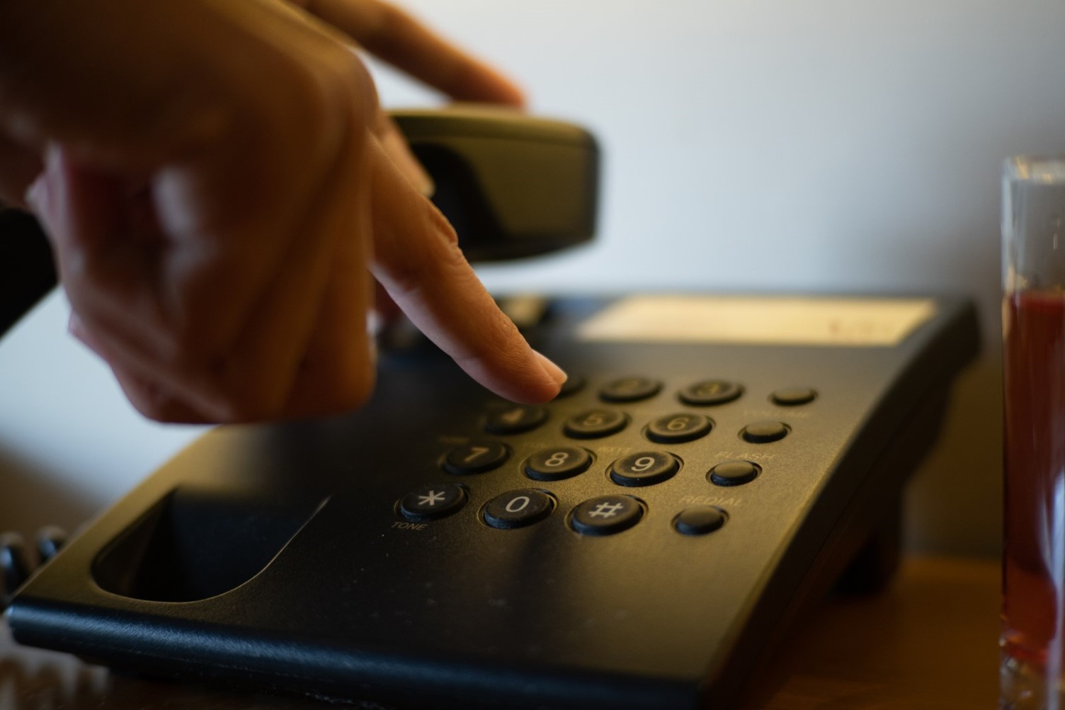 hand using touchtone phone