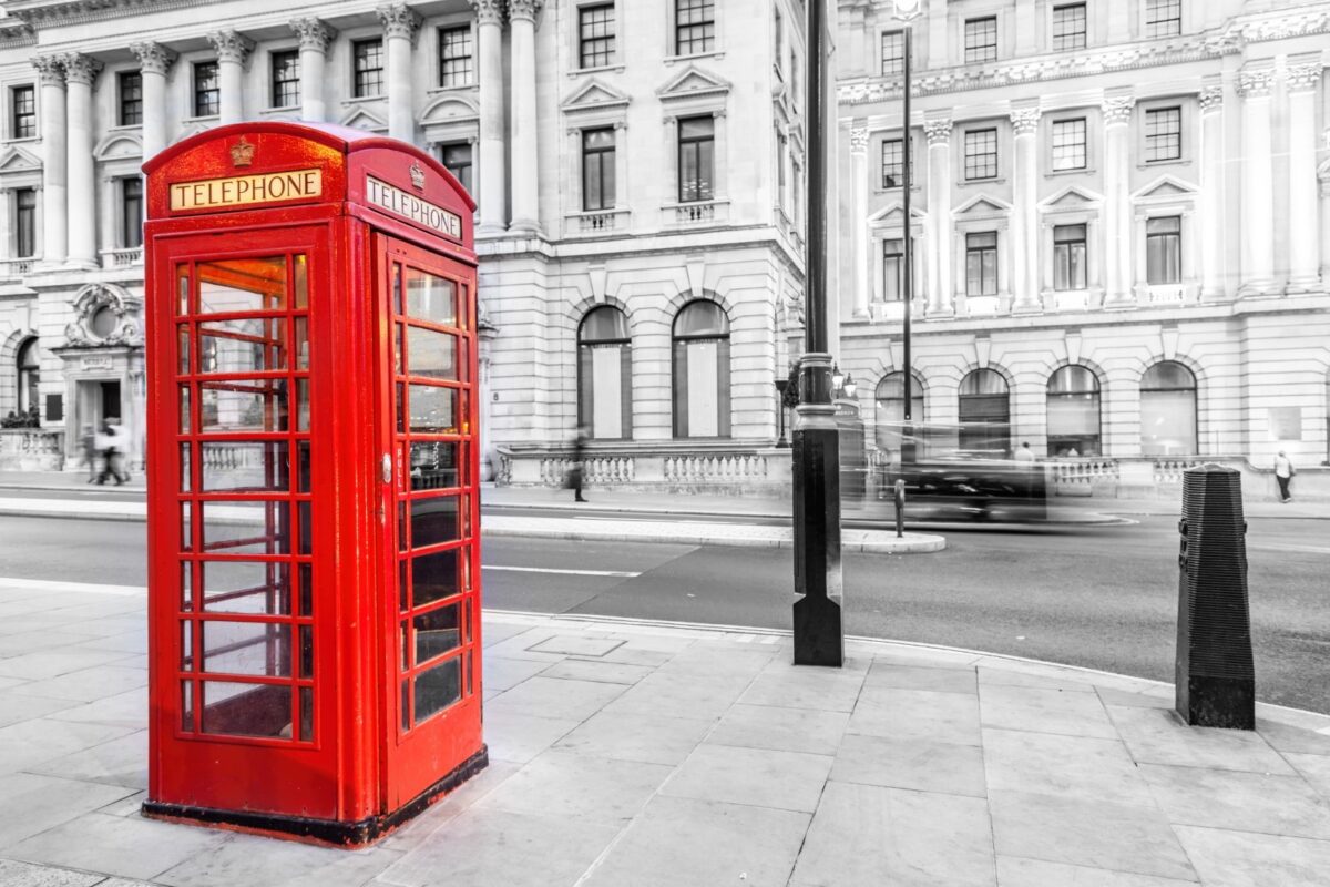 red telephone box on a black and white street