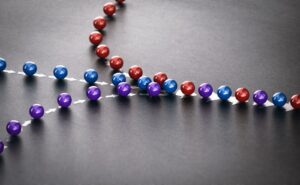three lines of red, blue, and purple marbles converging into one