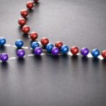three lines of red, blue, and purple marbles converging into one